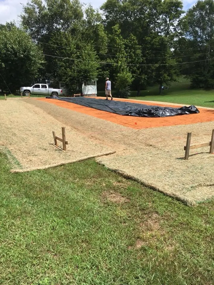 Prepared building pad with forms and stakes on a cleared lot