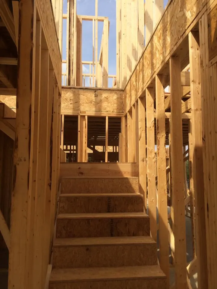 Framed stairway and walls inside a house under construction