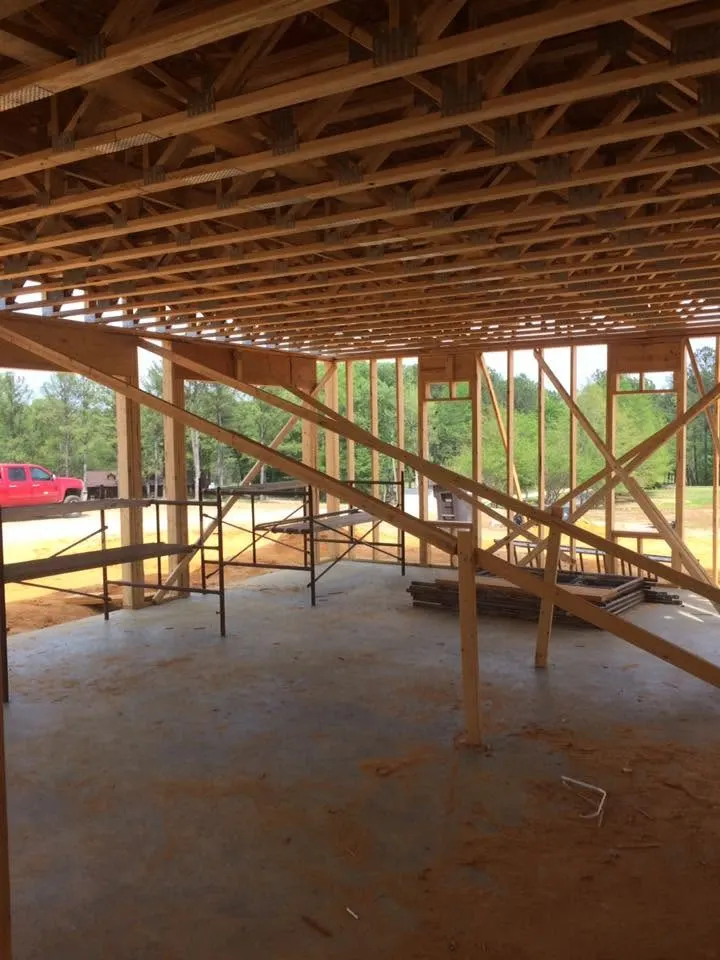 Open floor with ceiling joists and temporary supports in a framed house